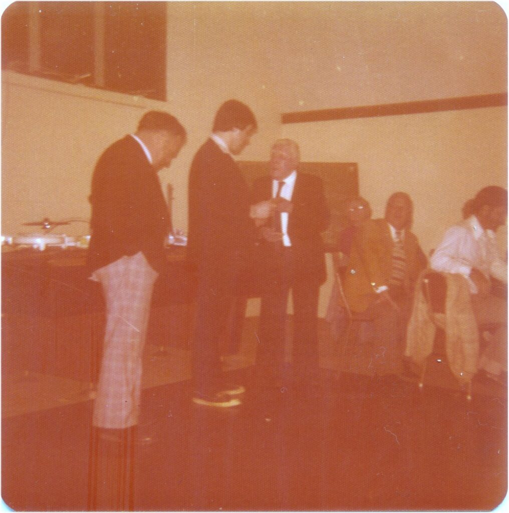 Me receiving my 21st key from my grandfather with my father looking on